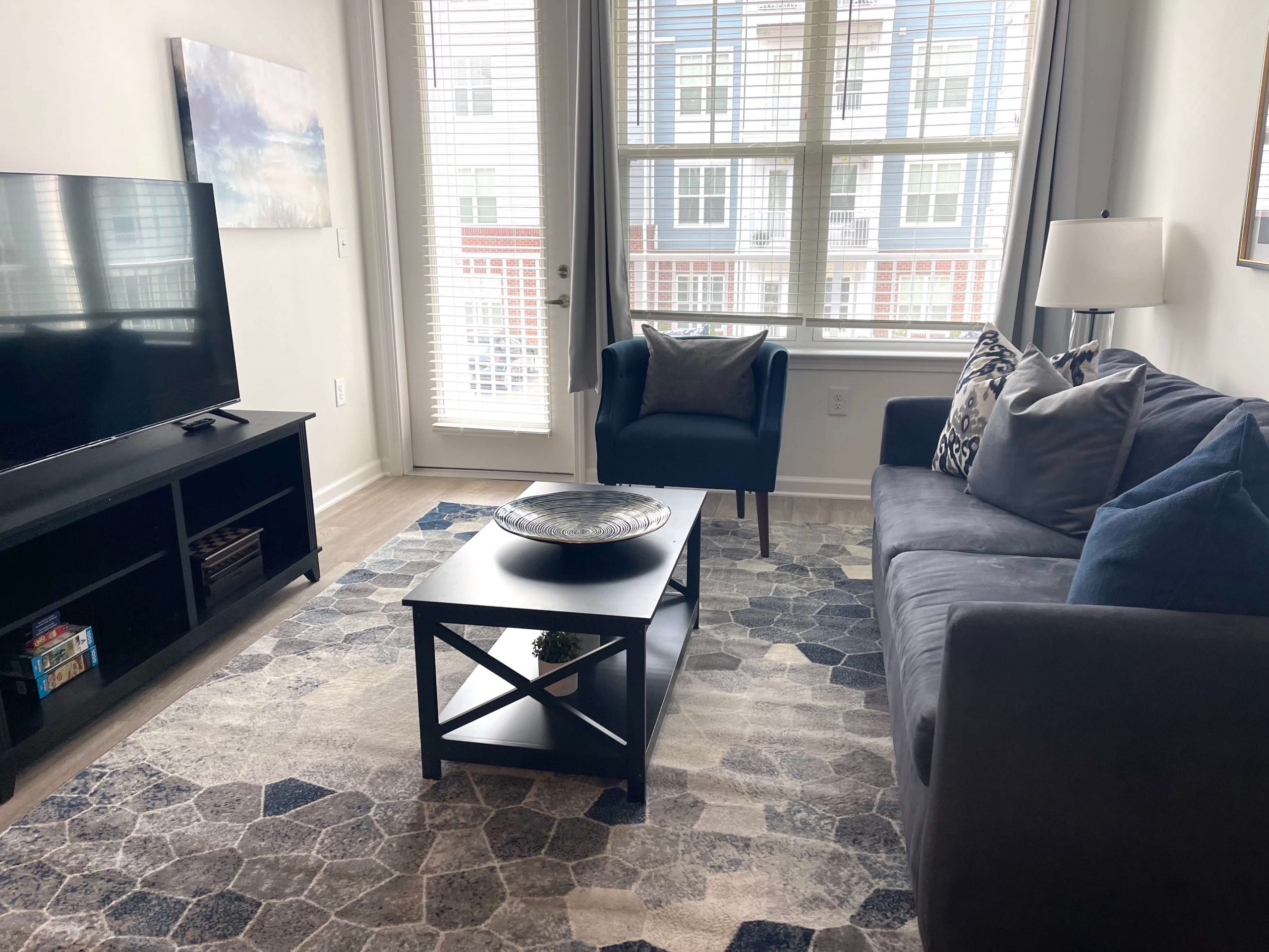 living room with gray sofa and tv