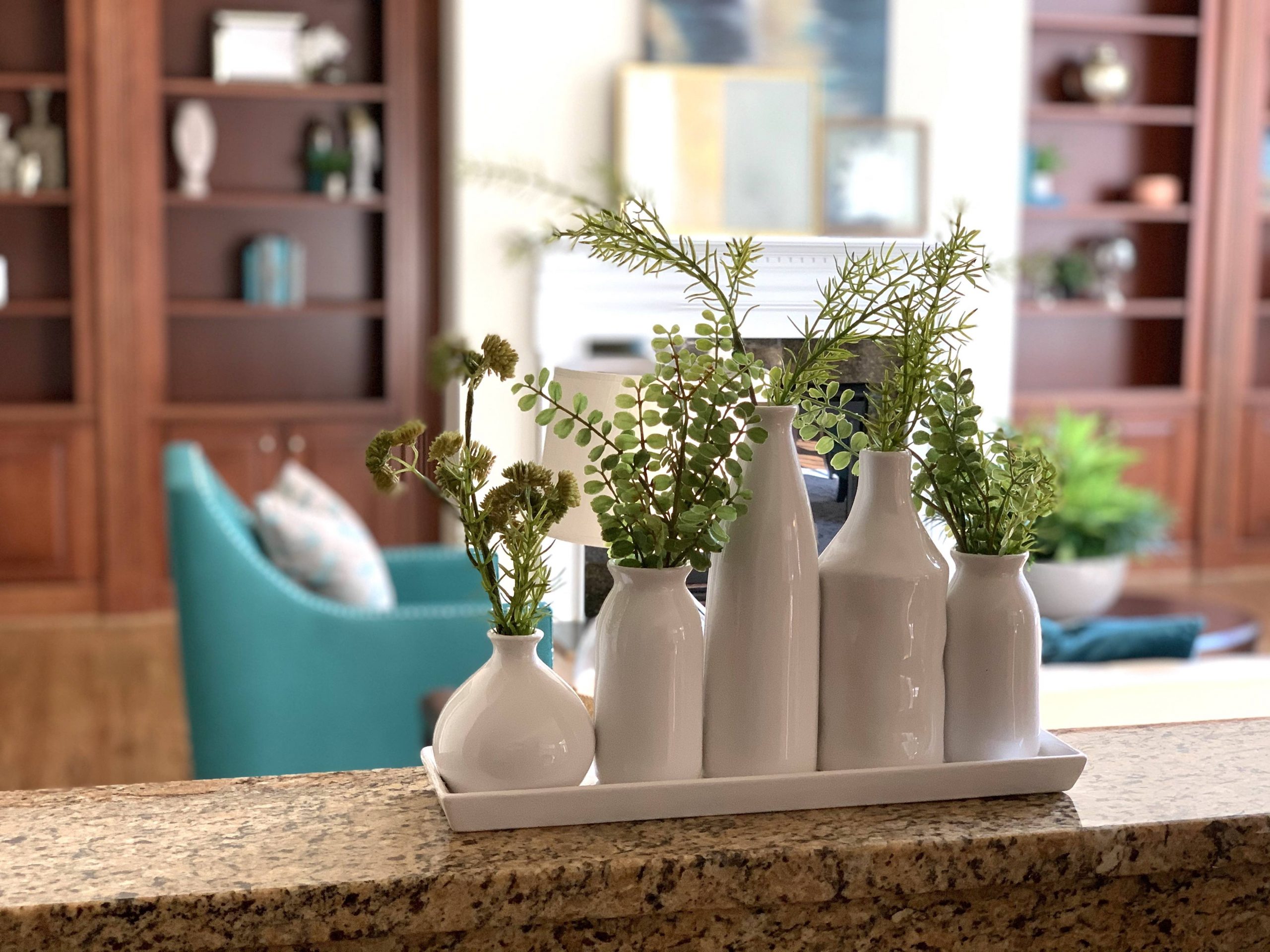 A vignette of vases and greenery in an occupied home by staging company in Richmond, VA