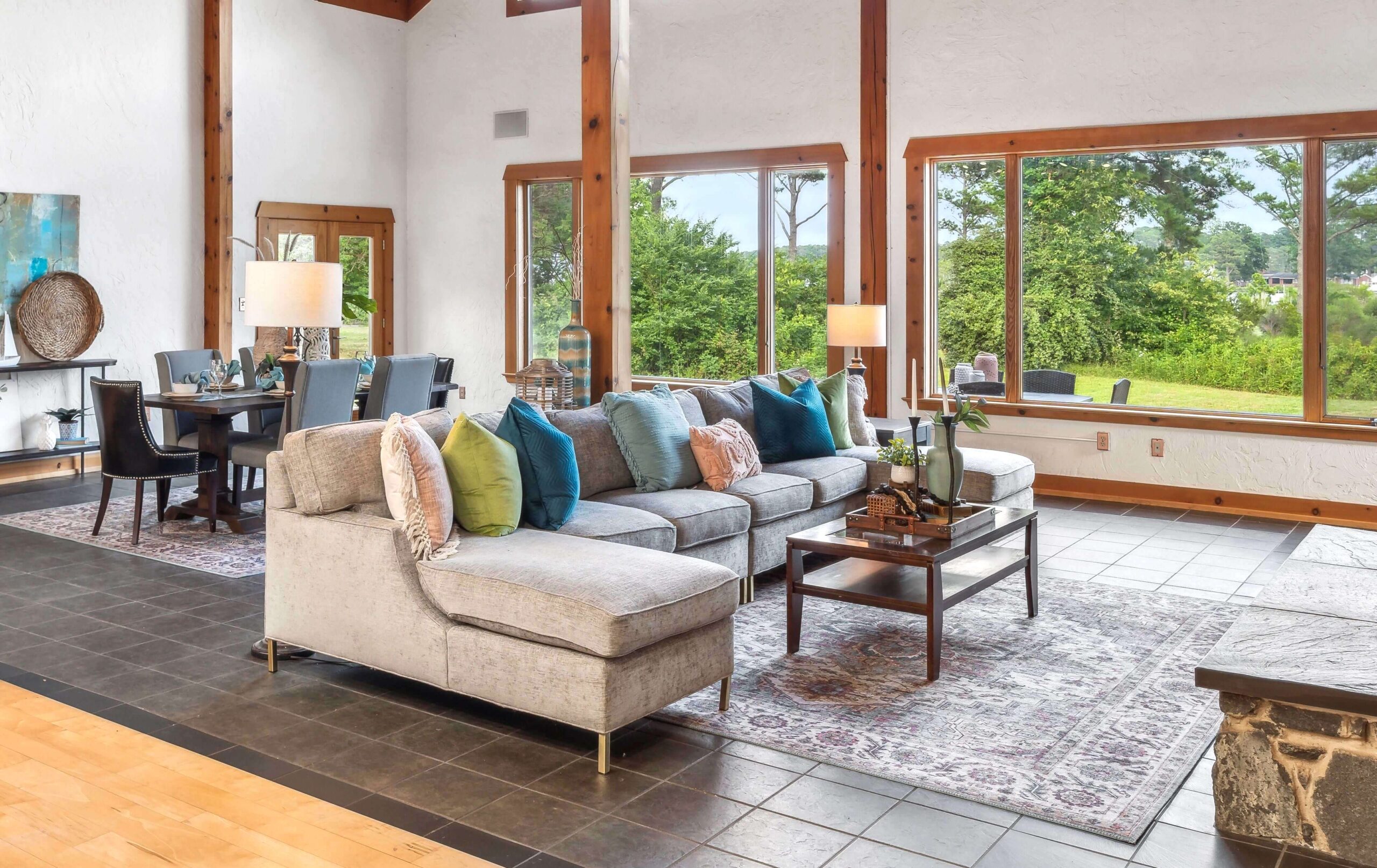 Professionally home staged great room with sectional sofa and colorful pillows